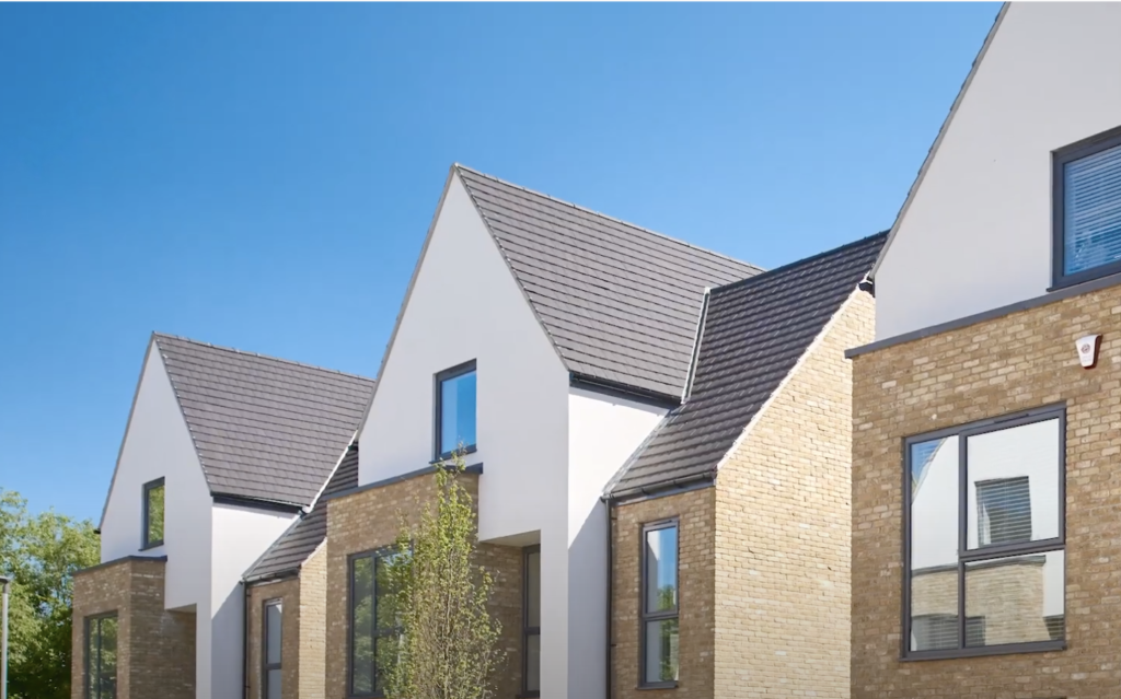 Roof detail of new modern homes against bright blue sky